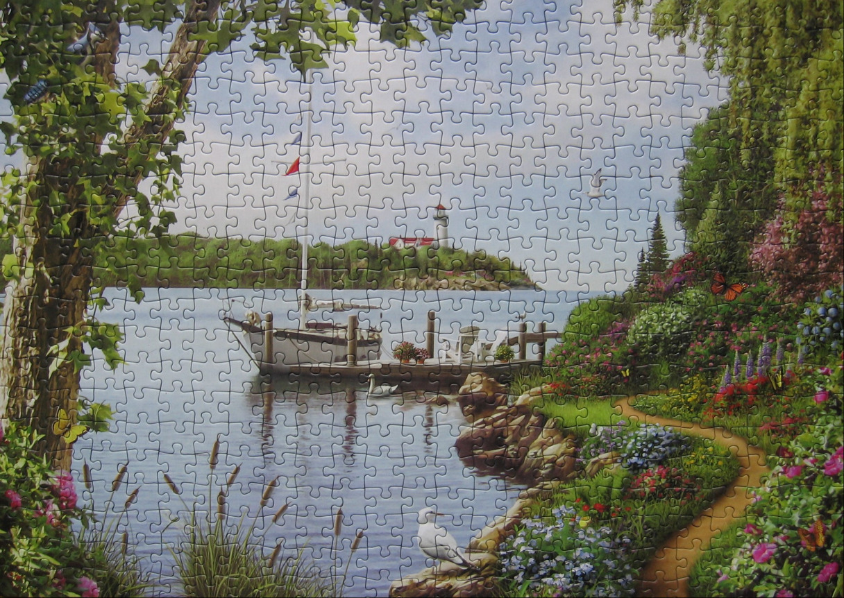 A peaceful coastal landscape featuring a sailboat moored at a dock with a lighthouse in the distance.