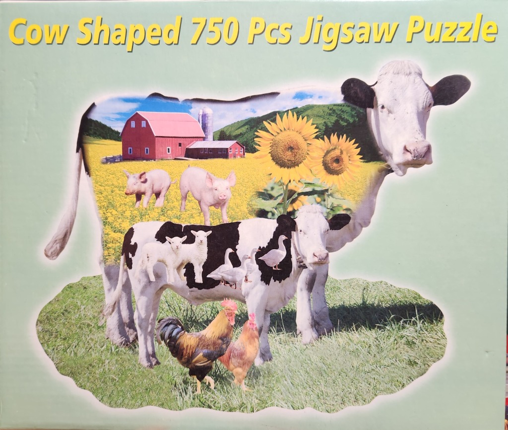 A collage of farm animals and a barn inside a cow-shaped silhouette.