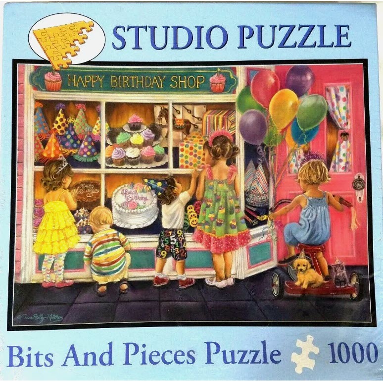 Children looking into a Happy Birthday Shop window filled with cakes and party supplies