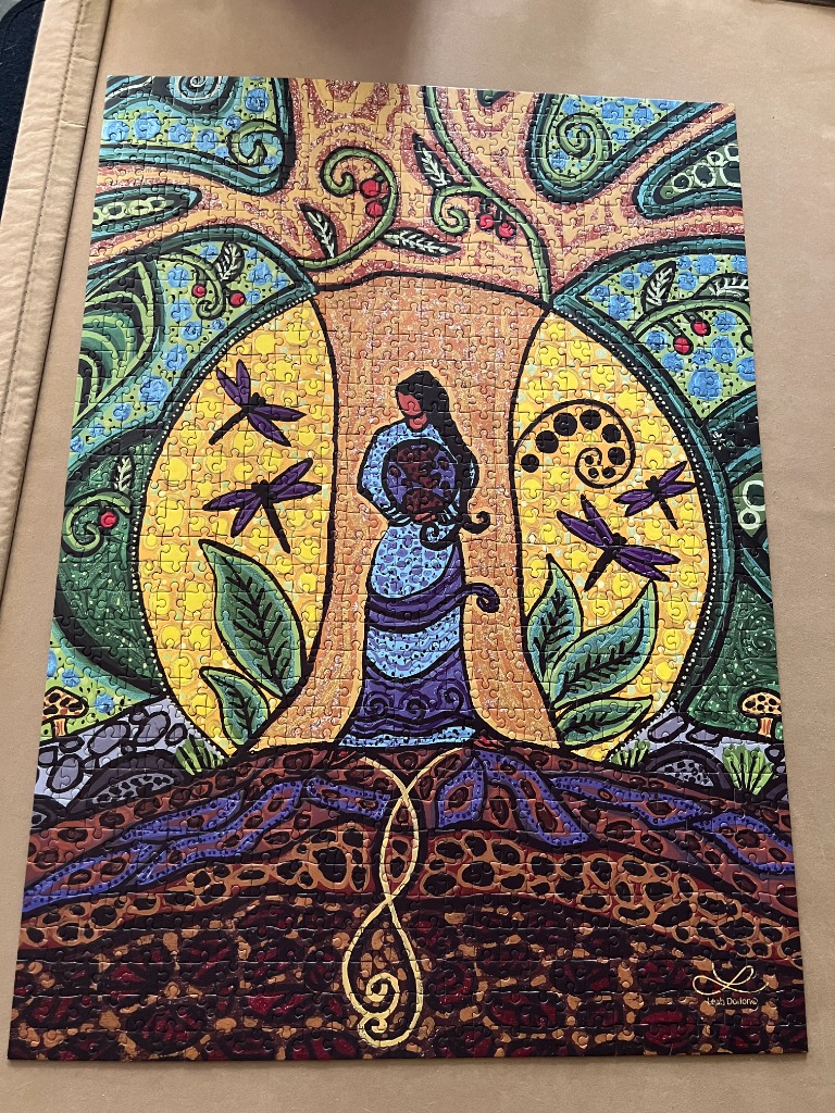 Artistic illustration of a woman standing beneath a stylized tree, surrounded by dragonflies and a golden sun.
