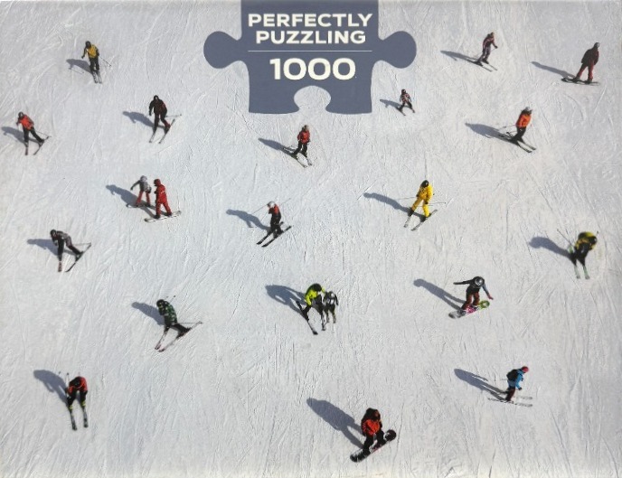 Aerial view of many individual skiers and snowboarders scattered across a vast, pristine white snowy slope.