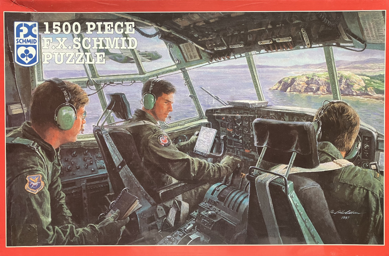 Three military pilots inside the cockpit of a cargo plane flying over a coastline.