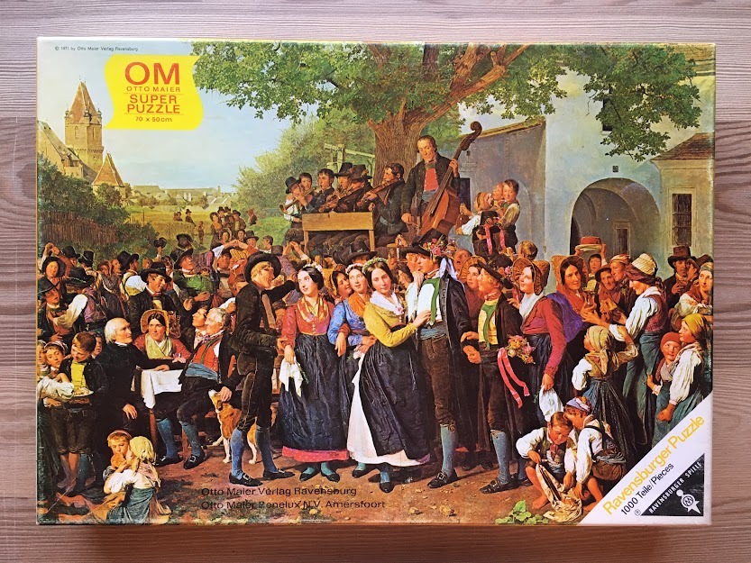 A detailed oil painting depicting a large, festive village gathering with musicians and people in traditional folk attire.
