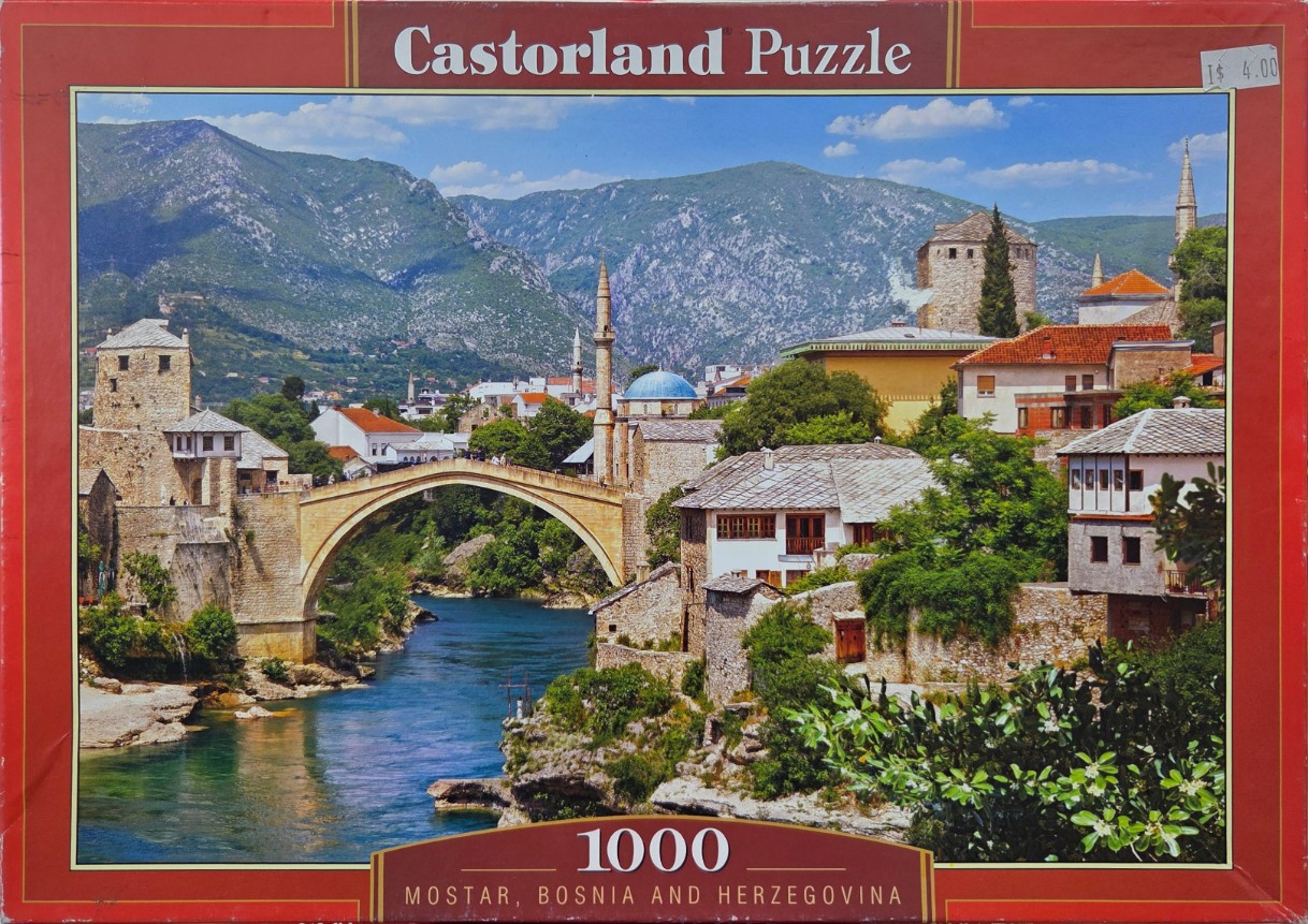 A panoramic photograph of the Stari Most bridge over the turquoise Neretva River in Mostar, Bosnia and Herzegovina.