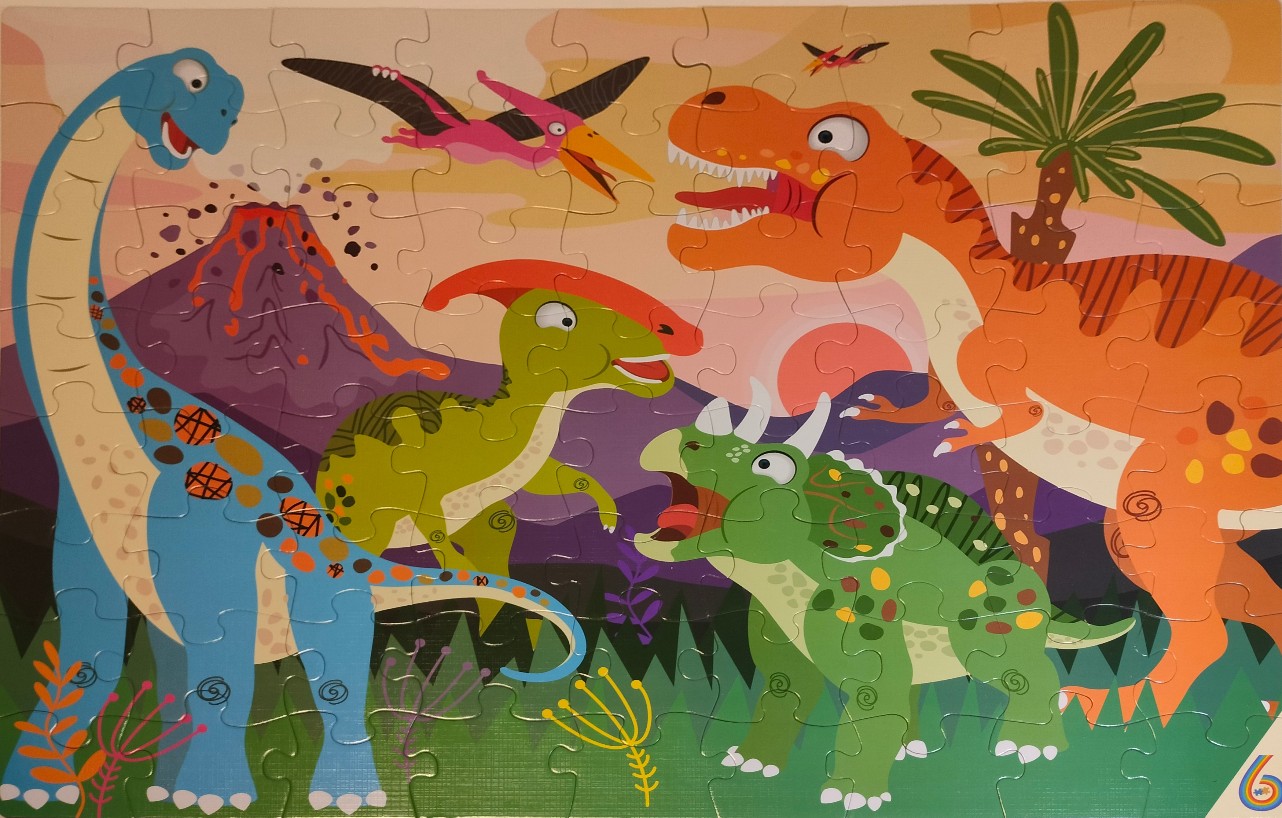 Cartoon illustration of four colorful dinosaurs in a prehistoric landscape with a volcano.