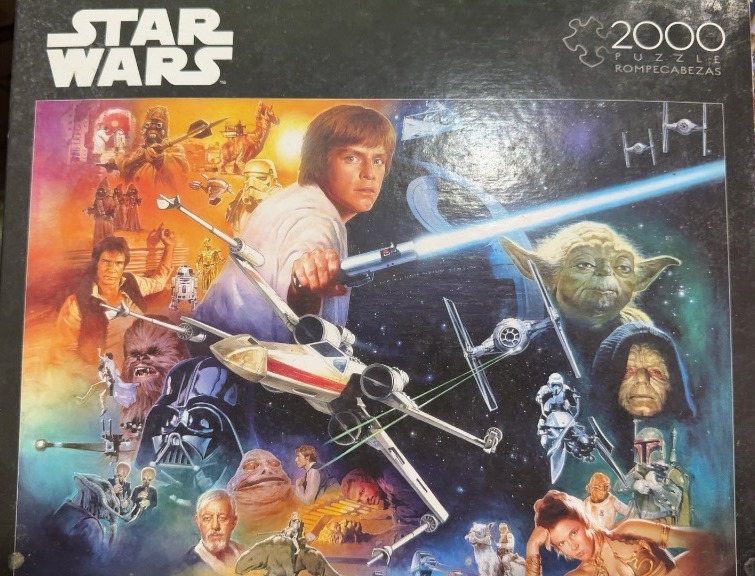 Collage of Star Wars characters and vehicles featuring Luke Skywalker with a lightsaber in the center.