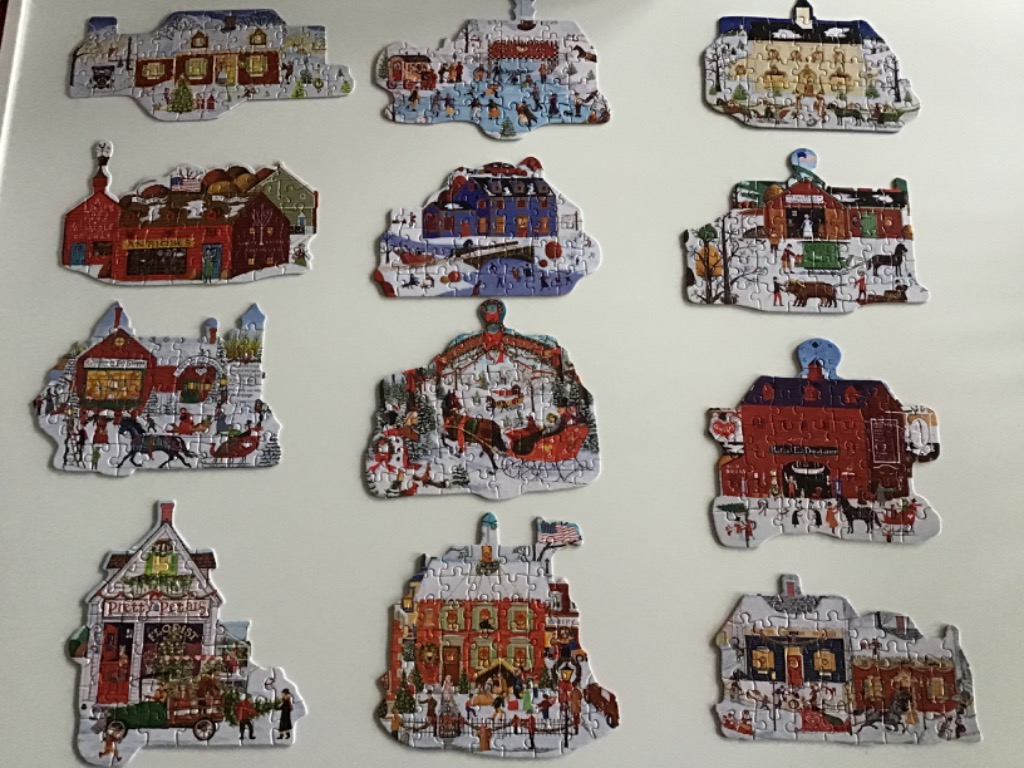 A collection of twelve individual holiday-themed village buildings and scenes arranged on a white background.