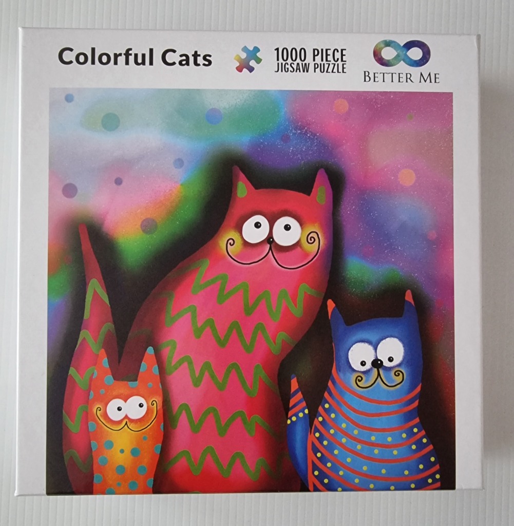 A whimsical illustration of three cats in bright, vibrant colors against a dreamy, nebula-like background.