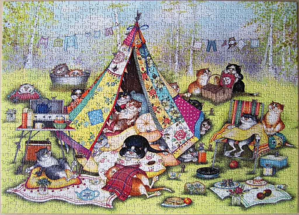 A whimsical illustration of many cats camping in a colorful tent in a forest clearing.