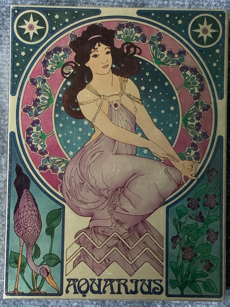 Art Nouveau style illustration of a woman representing the Aquarius zodiac sign, surrounded by stars and floral motifs.