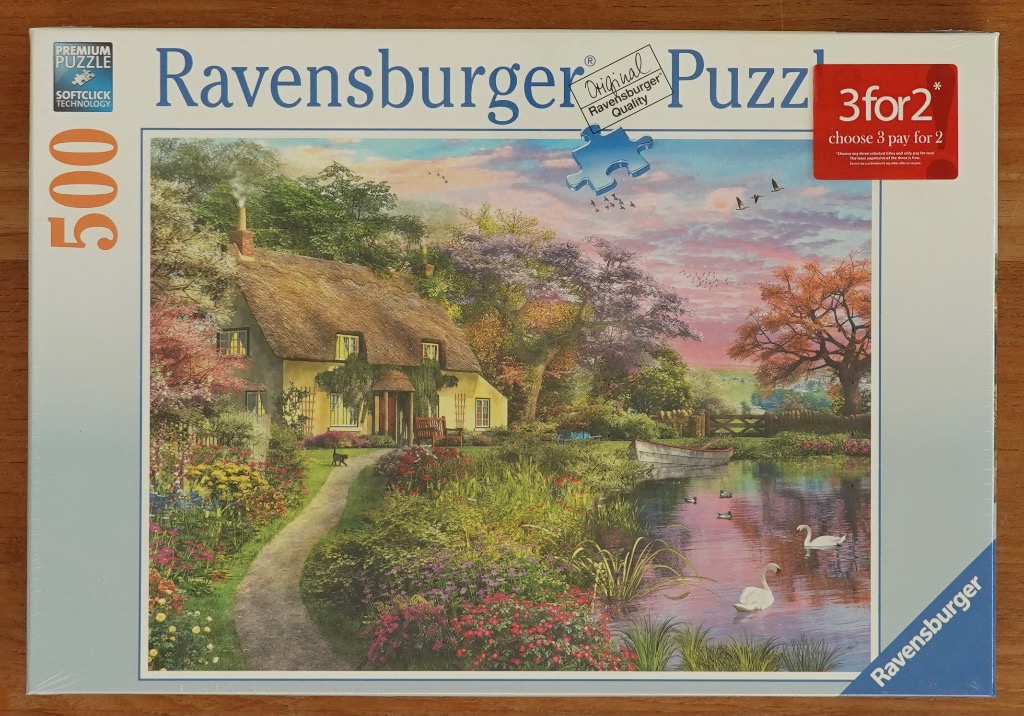 A peaceful English cottage scene with a thatched roof, gardens, a pond with swans, and a pink-hued sunset.
