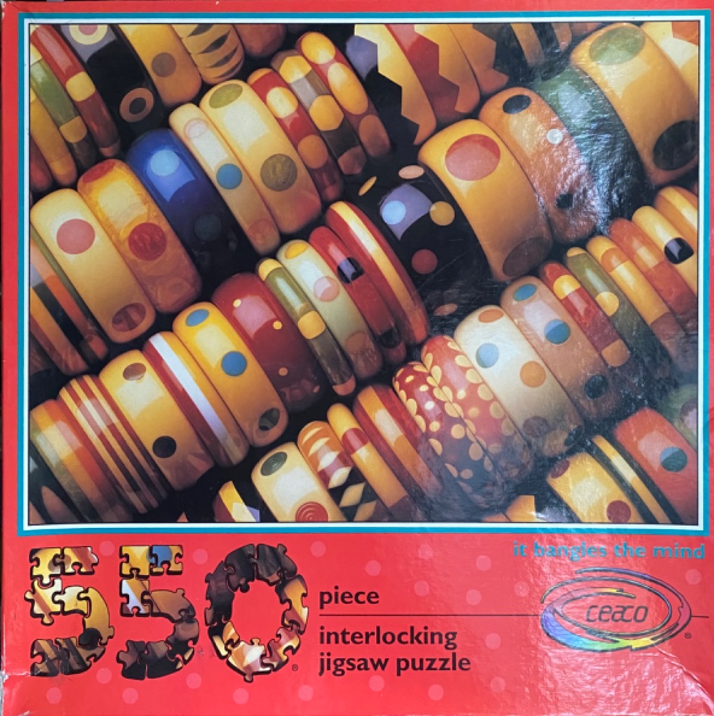 A close-up photograph of a large collection of colorful, patterned wooden bangle bracelets stacked and arranged together.
