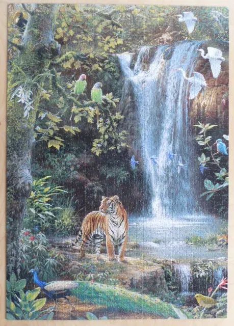 A tiger standing in a lush tropical jungle near a waterfall with various birds flying and perching nearby.