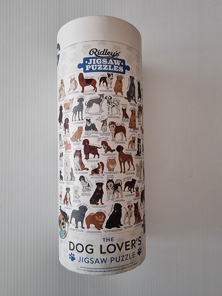 The Dog Lover's Jigsaw Puzzle features a collage of various dog breeds on a cylindrical box.