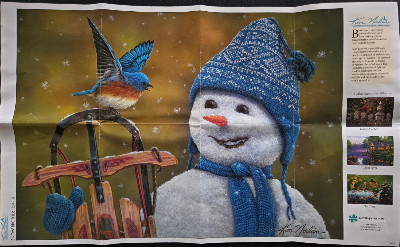 A bluebird perches on a wooden sled next to a smiling snowman wearing a blue knit hat and scarf in a winter scene.
