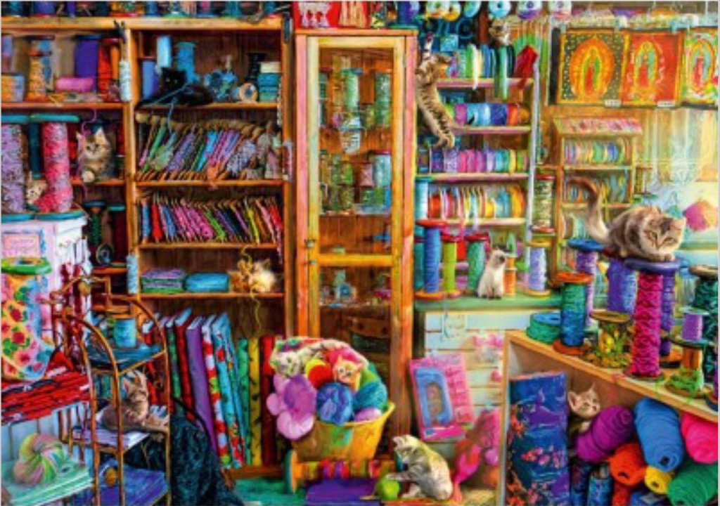 A cozy, cluttered craft room filled with shelves of vibrant ribbons, yarn, fabric, and numerous playful cats.