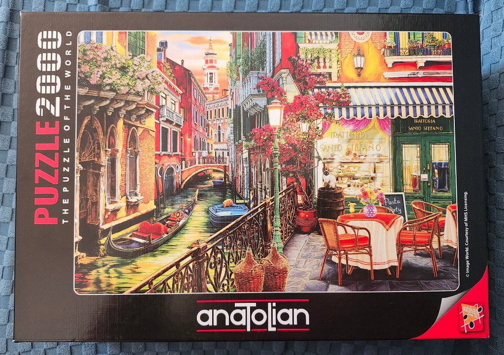 A vibrant painting of a sunlit Venice canal with a restaurant terrace, a gondola, and flowers.