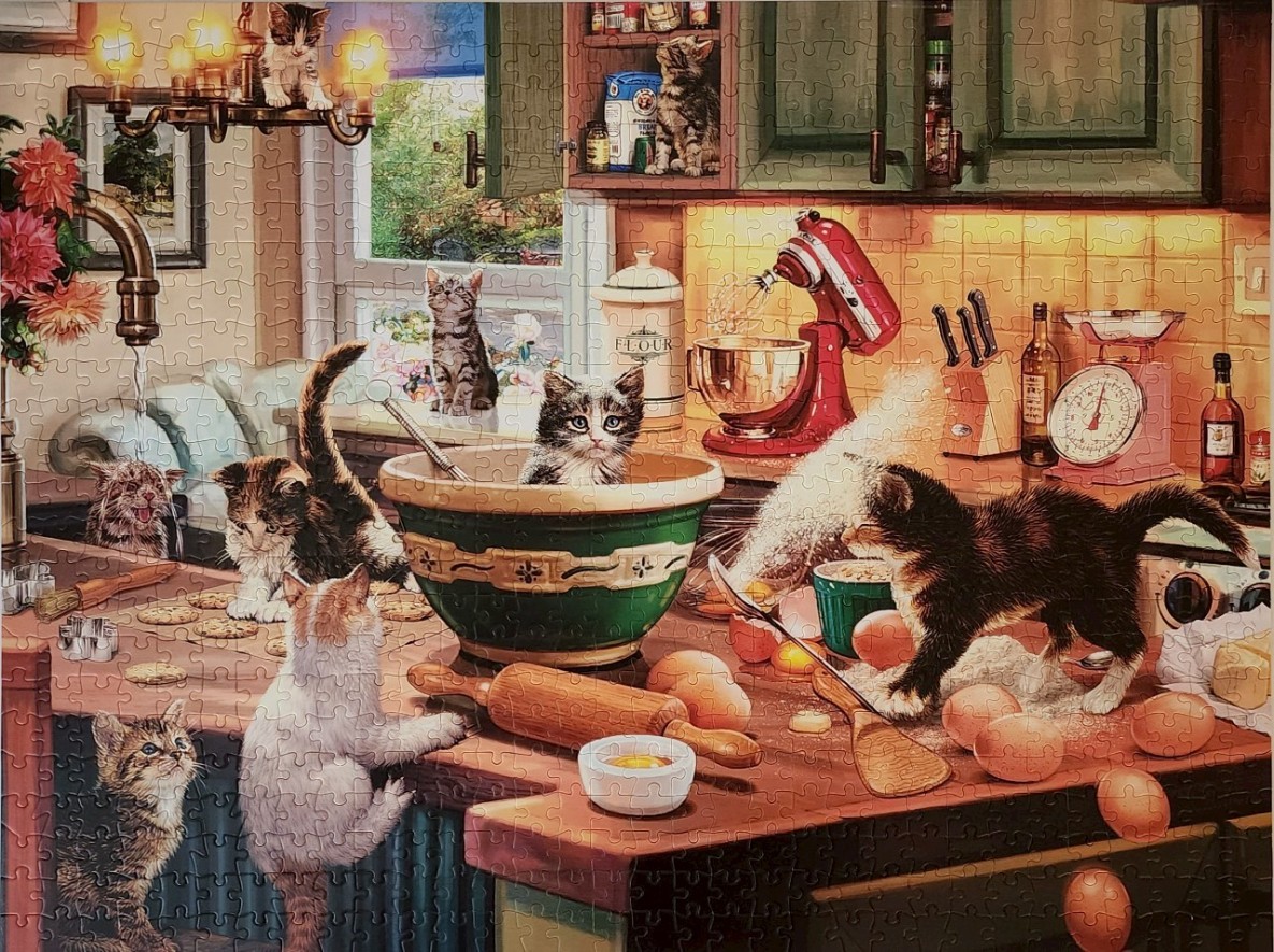 A cozy kitchen scene bustling with several mischievous kittens baking and playing.