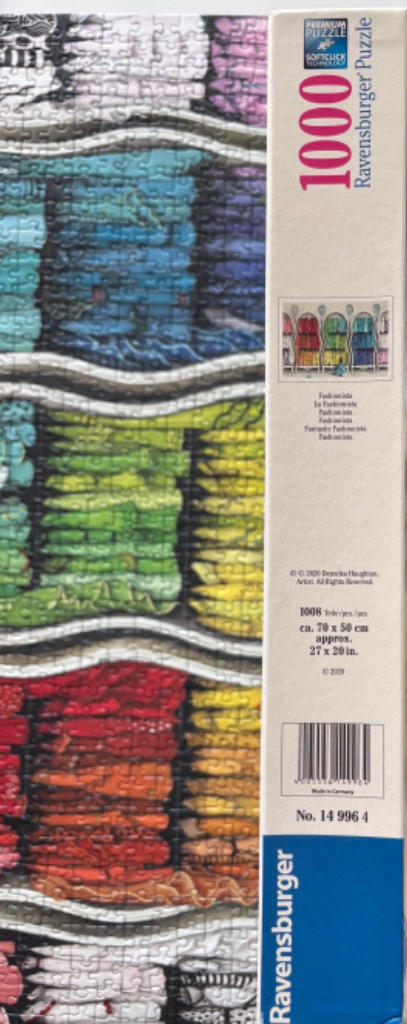 Colorful spools of thread in rainbow hues.