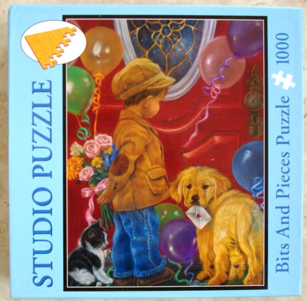 Young boy in a flat cap holding flowers with a golden retriever puppy and a kitten by a red front door.