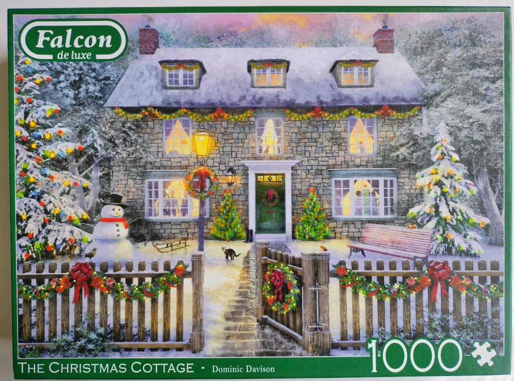 A cozy stone cottage decorated for Christmas in a snow-covered garden with a snowman and festive lights.