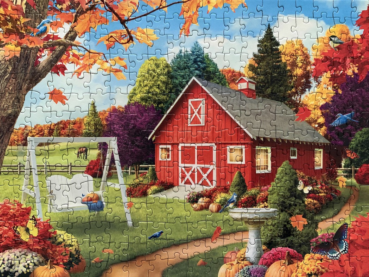 A red barn in an autumn garden with a white porch swing, pumpkins, and birds.