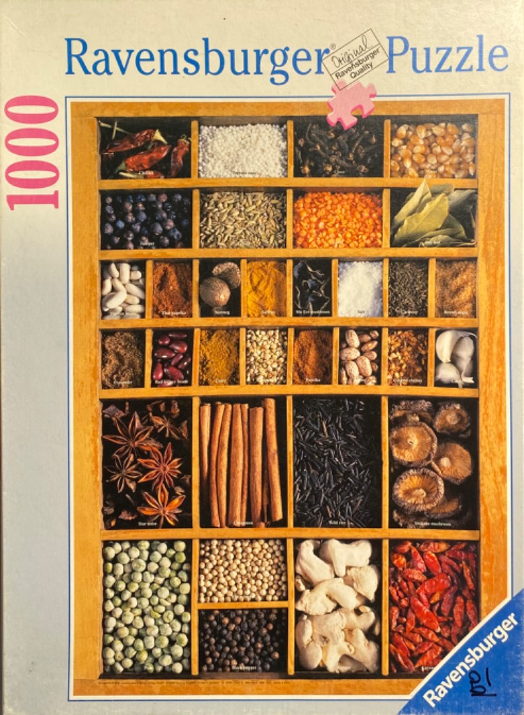 A wooden spice rack filled with various dry ingredients like star anise, cinnamon, dried peppers, and legumes.