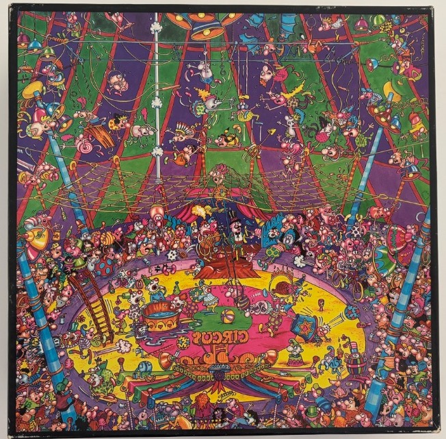 A crowded, humorous cartoon illustration of a circus tent filled with chaotic performers and spectators.