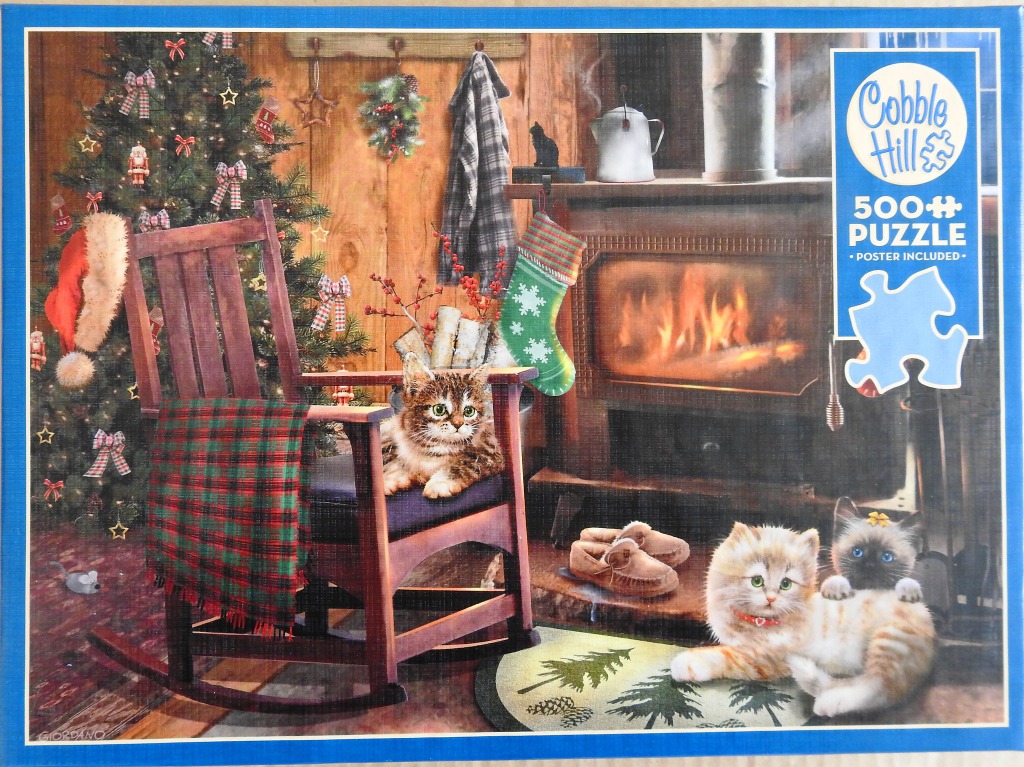 Three kittens in a cozy, festive living room with a fireplace and Christmas tree.