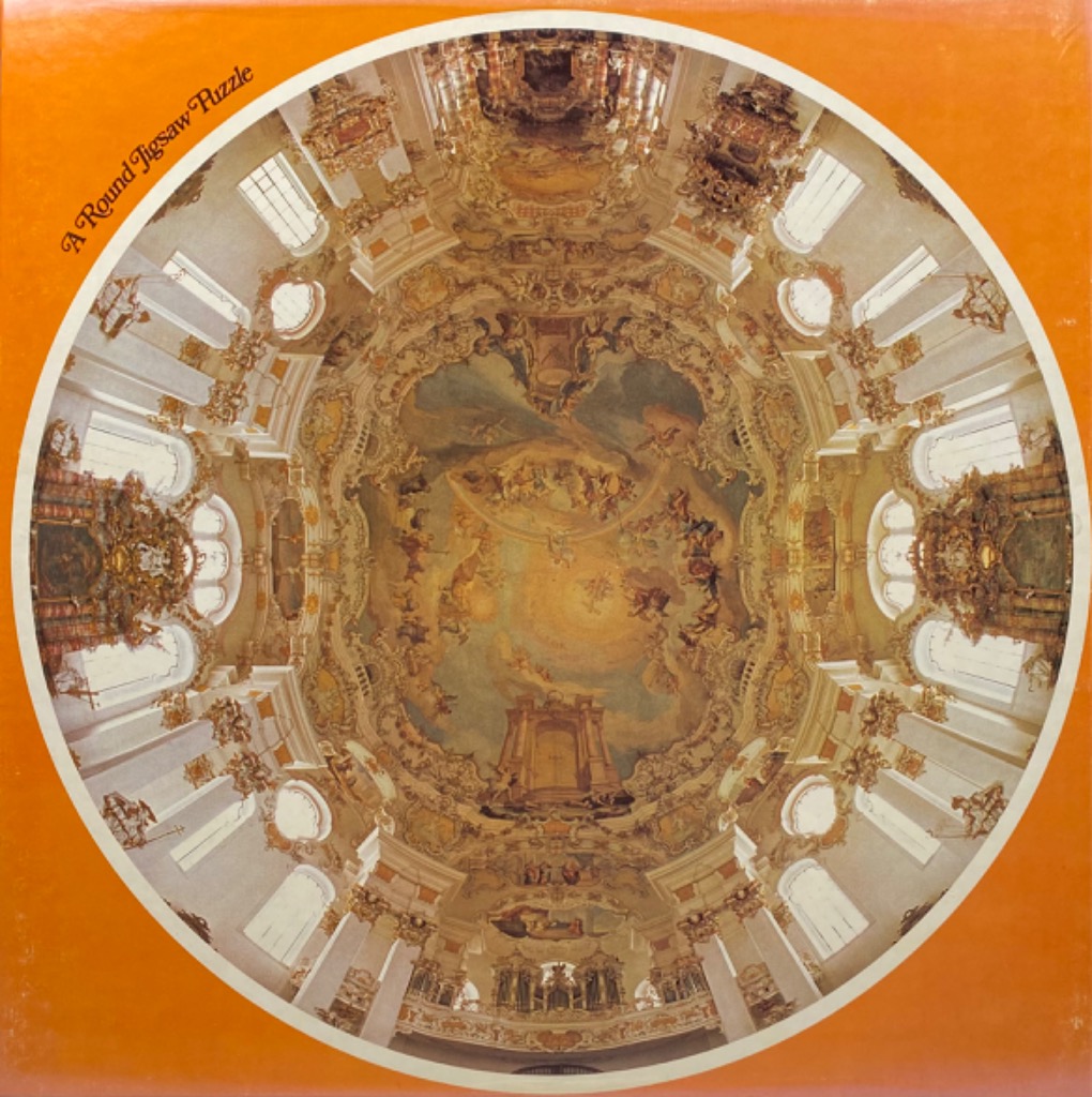A low-angle, circular photograph of an ornate, Rococo-style church interior dome featuring elaborate ceiling frescoes.