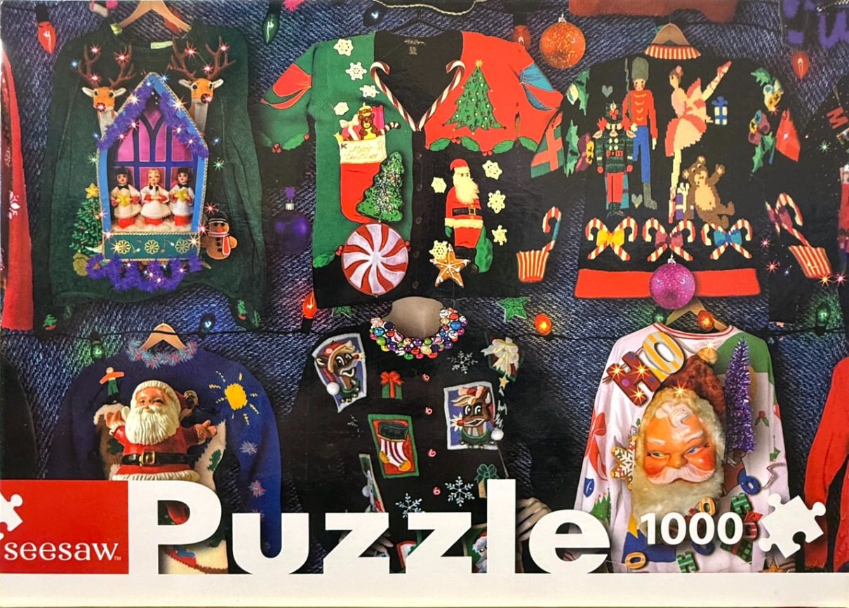 A collection of colorful and kitschy Christmas sweaters hanging against a dark blue denim background.