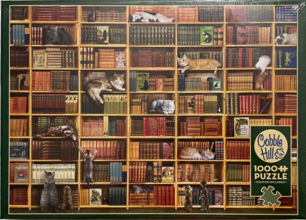 A tall, overflowing wooden bookshelf filled with many colorful books and various cats resting on the shelves.