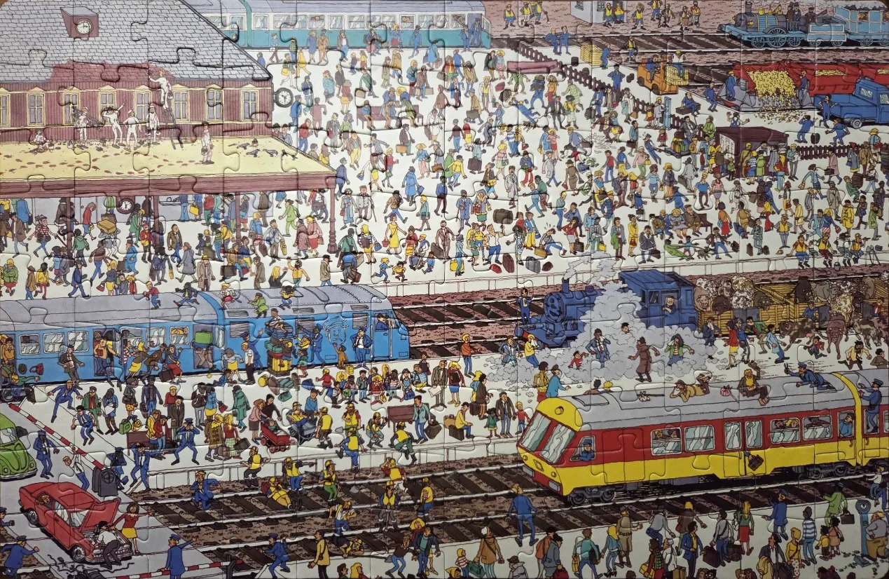 A bustling, highly detailed cartoon scene of a busy train station filled with hundreds of people and several trains.