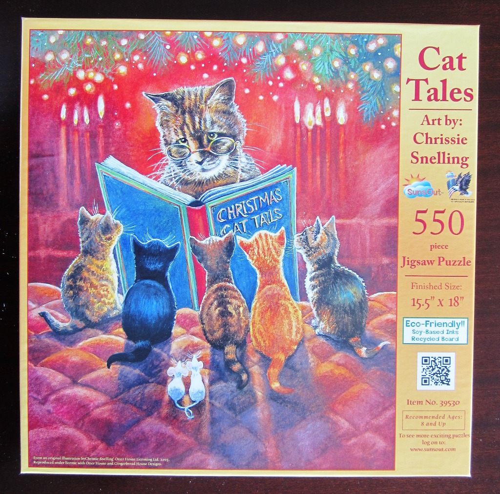 A tabby cat wearing glasses reading a book to five kittens in front of a red fireplace.