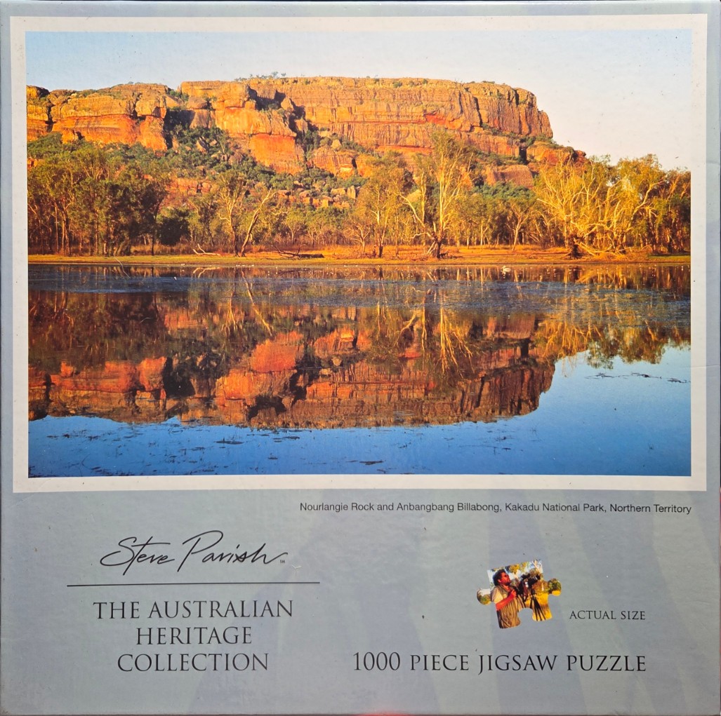 A photograph of Nourlangie Rock towering above the still, reflective waters of Anbangbang Billabong in Kakadu.