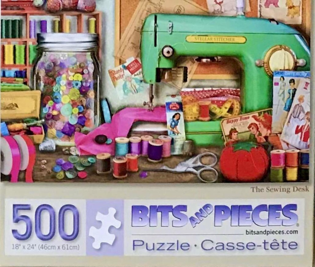 A colorful vintage sewing desk featuring a green sewing machine, a jar of buttons, and various sewing supplies.