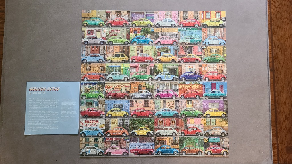 A collage of 42 colorful vintage Volkswagen Beetle cars parked in front of vibrant buildings.