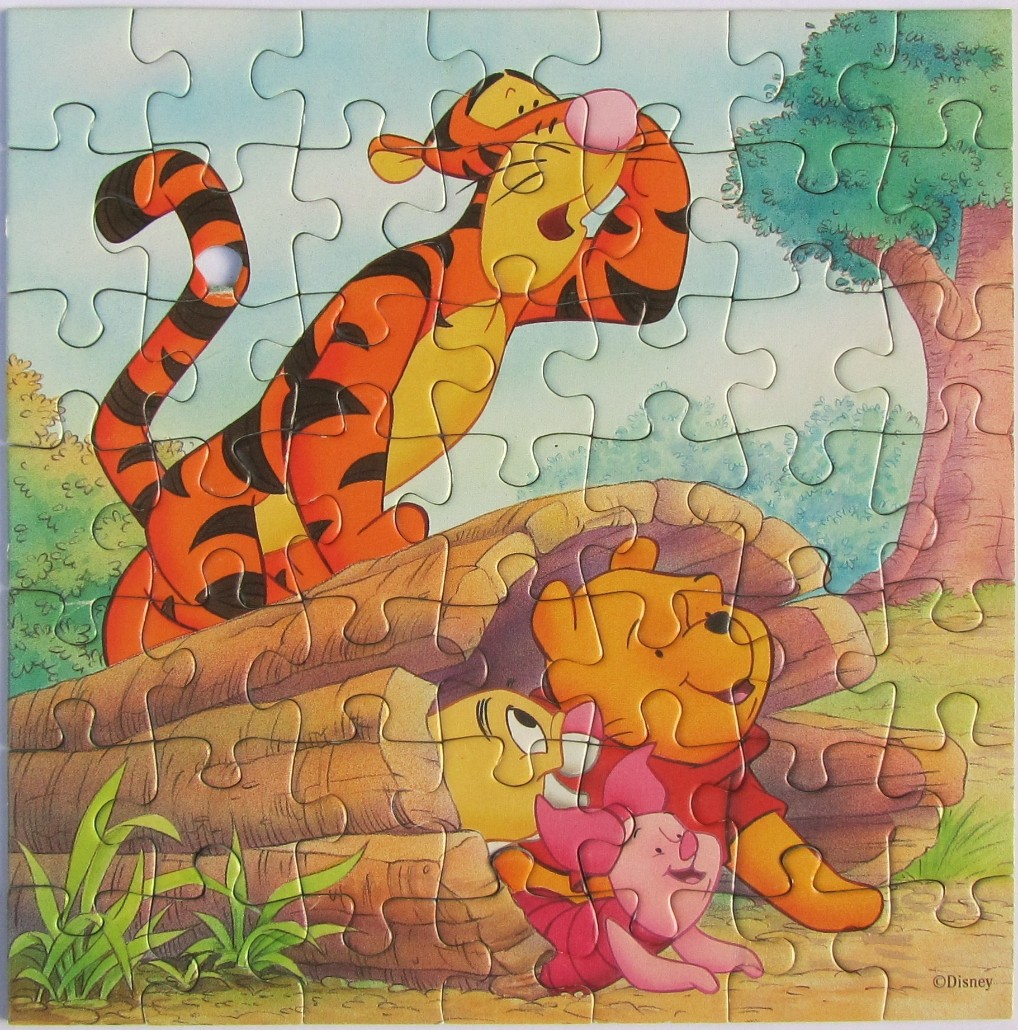 Tigger, Winnie the Pooh, and Piglet resting near a log in a sunny forest setting.