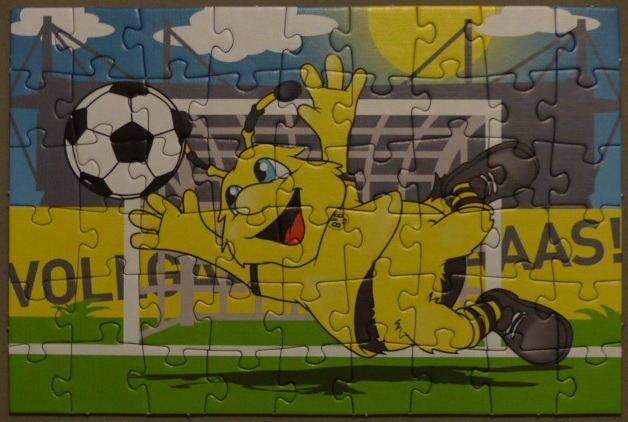 A cartoon yellow bee mascot diving to save a soccer ball in front of a stadium goal.