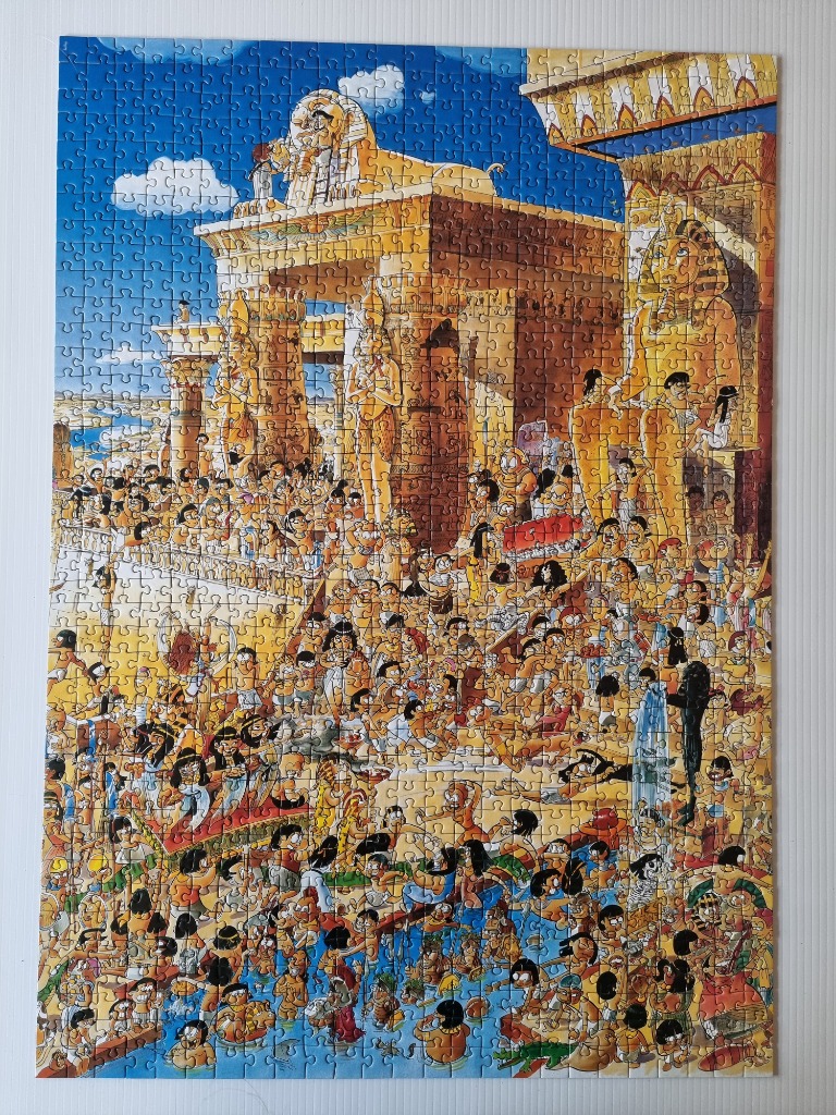 Cartoon illustration of a busy, comedic scene set in ancient Egypt with temples and crowds of people.
