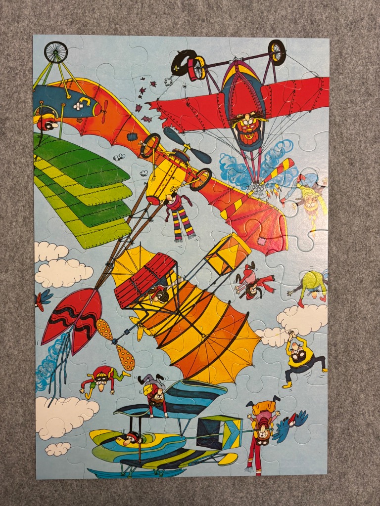 Cartoon illustration of chaotic flying machines and figures in a light blue sky