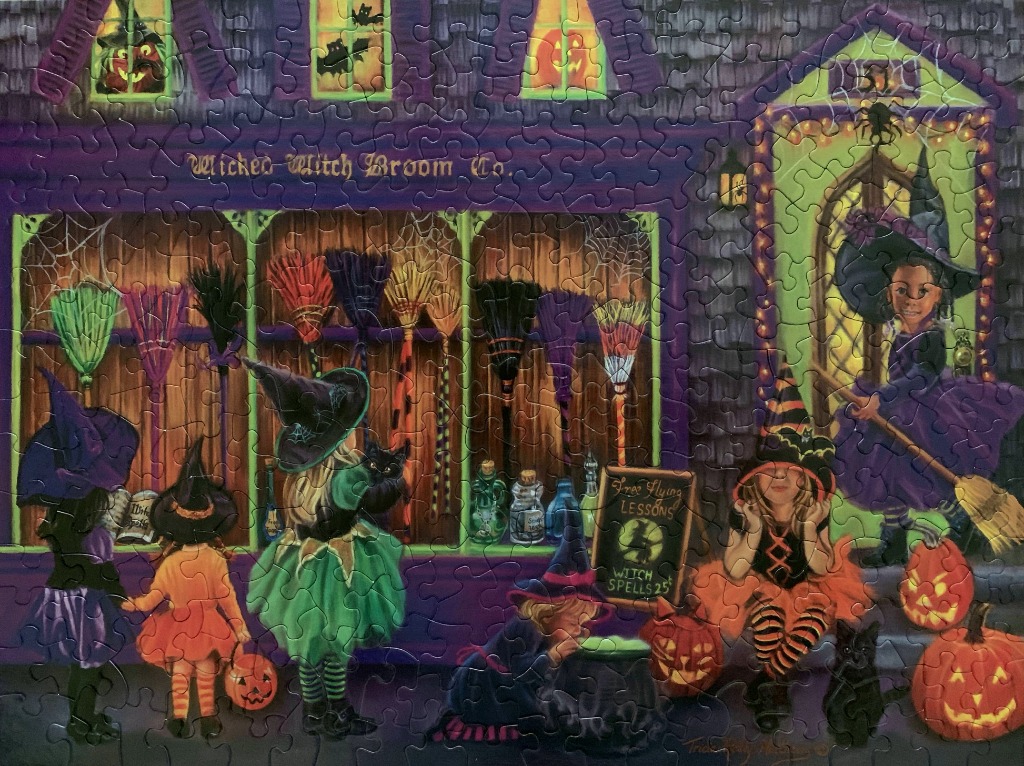 A whimsical illustration of a shop called the Wicked Witch Broom Co. with children in witch costumes outside.