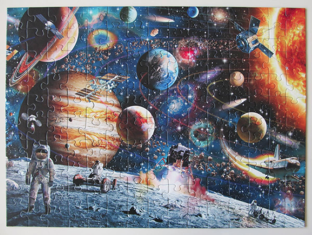 A vibrant space collage featuring planets, a space shuttle, astronauts, and celestial bodies.