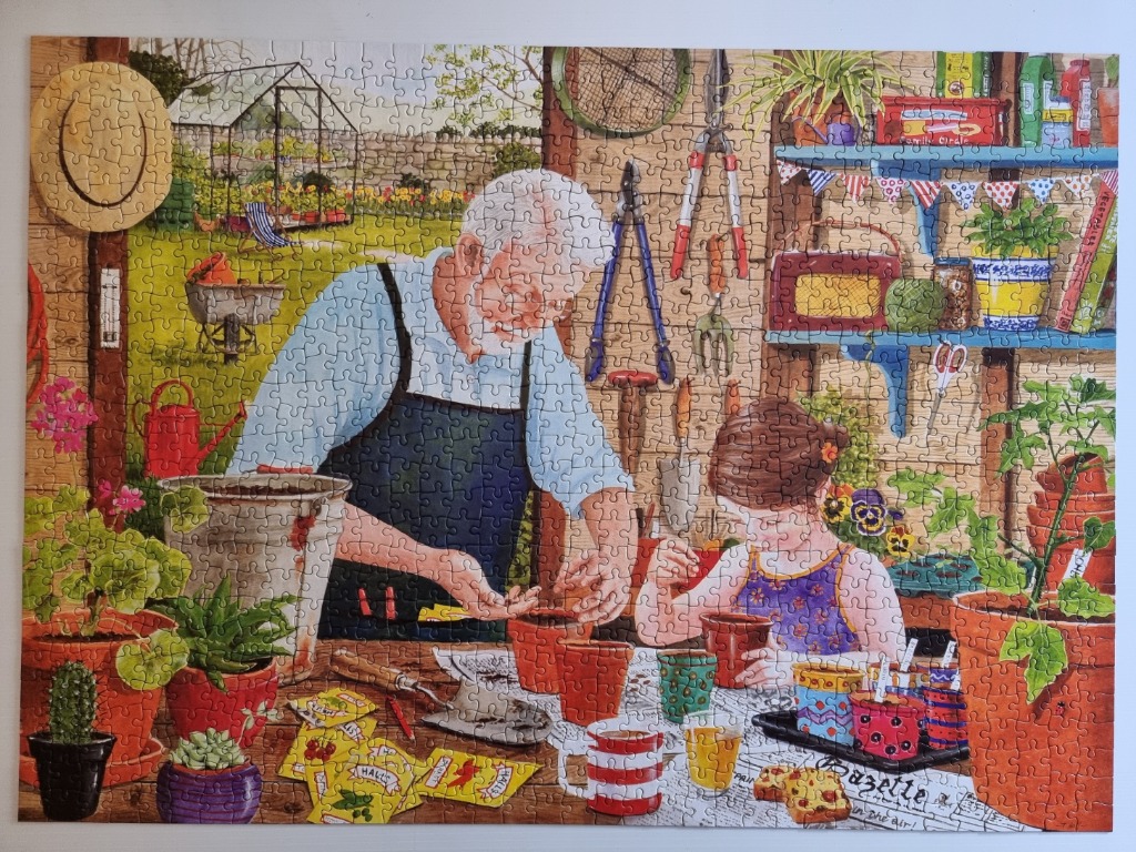 An elderly man and a young girl gardening together in a rustic potting shed.