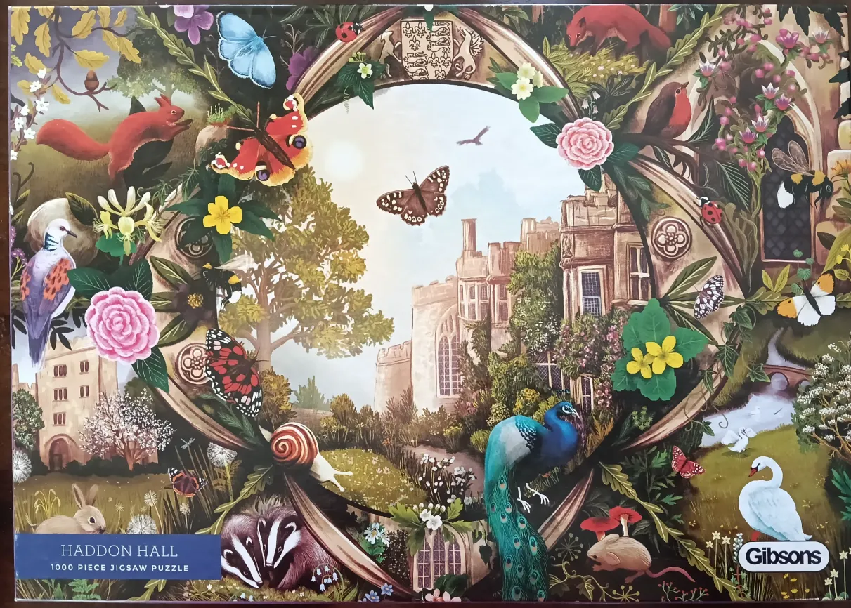 An ornate oval frame of British wildlife and flowers surrounding a classic stone manor house scene.