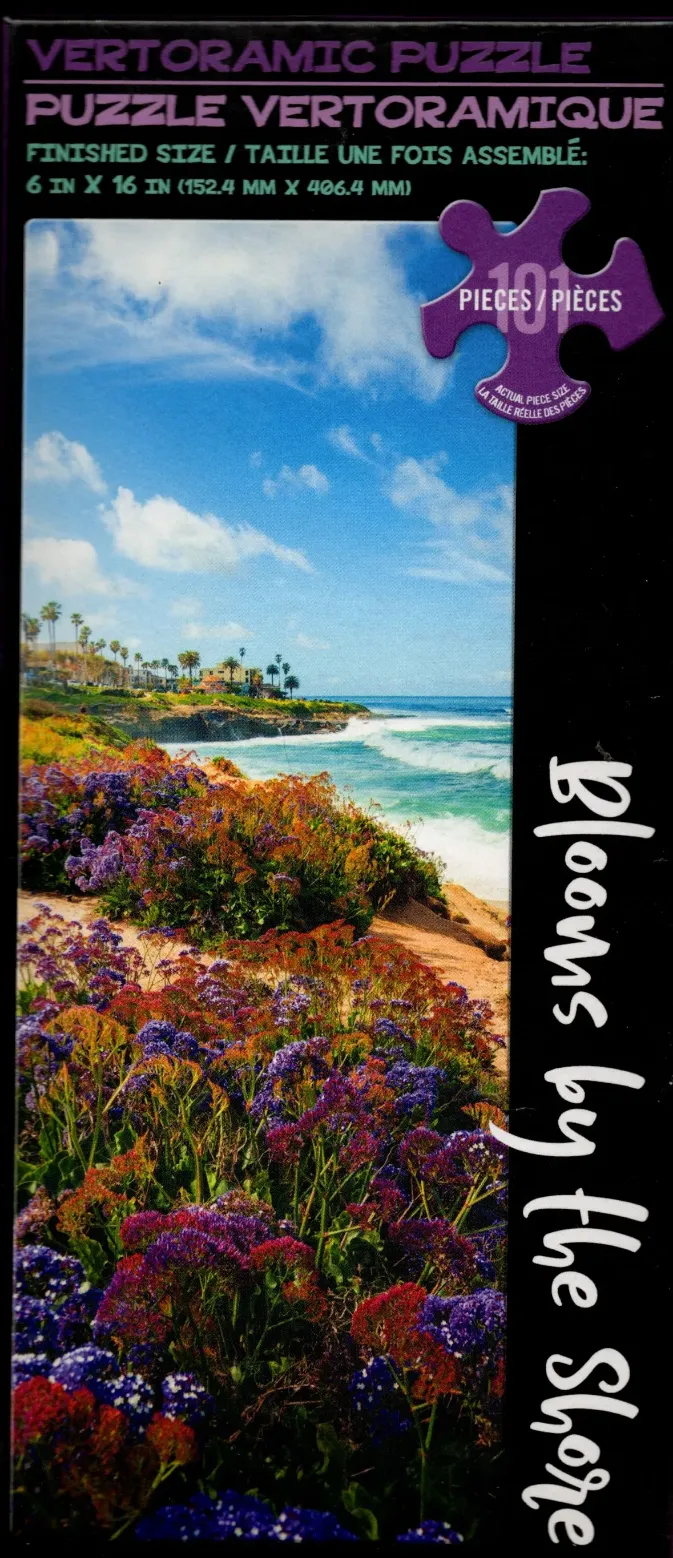 A panoramic photograph of a California coastline featuring vibrant purple sea lavender flowers in the foreground.
