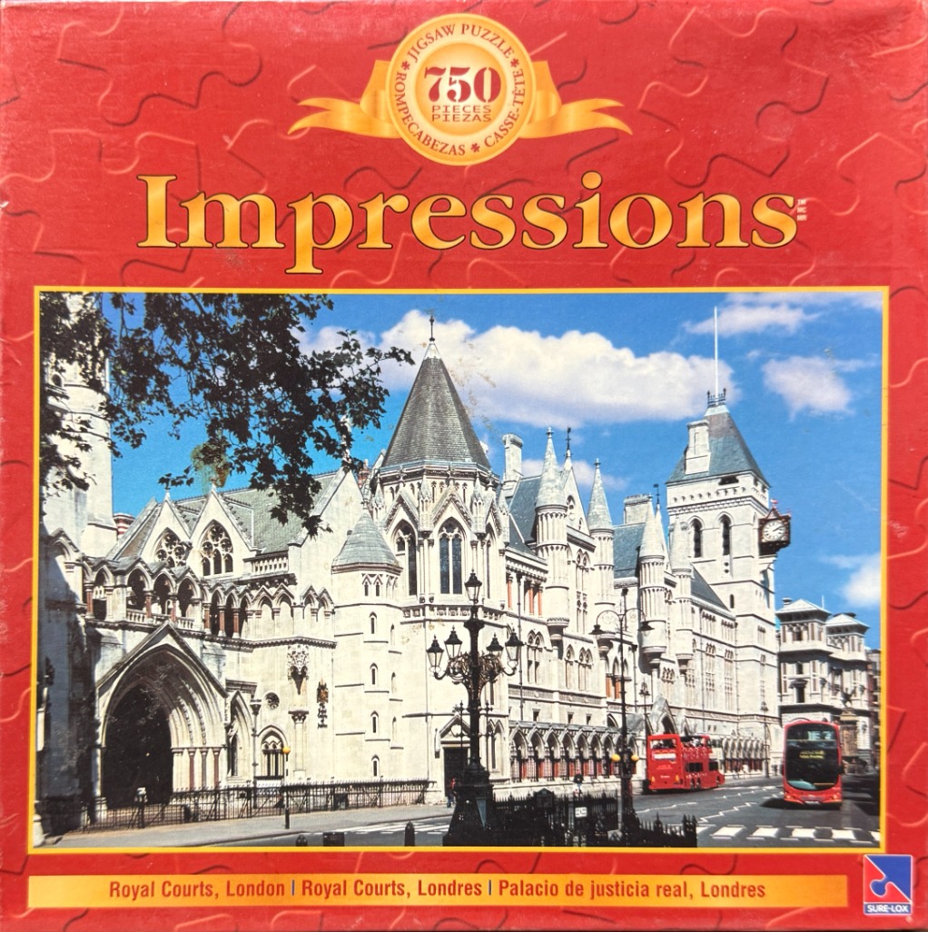 A photograph of the Royal Courts of Justice in London, showing the grand Victorian Gothic architecture and a red bus.