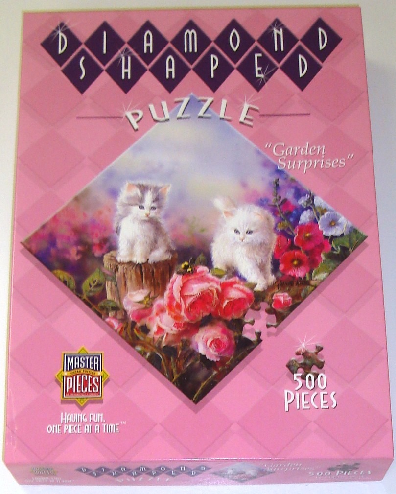 Two fluffy kittens sit among pink roses and green foliage in a garden setting.