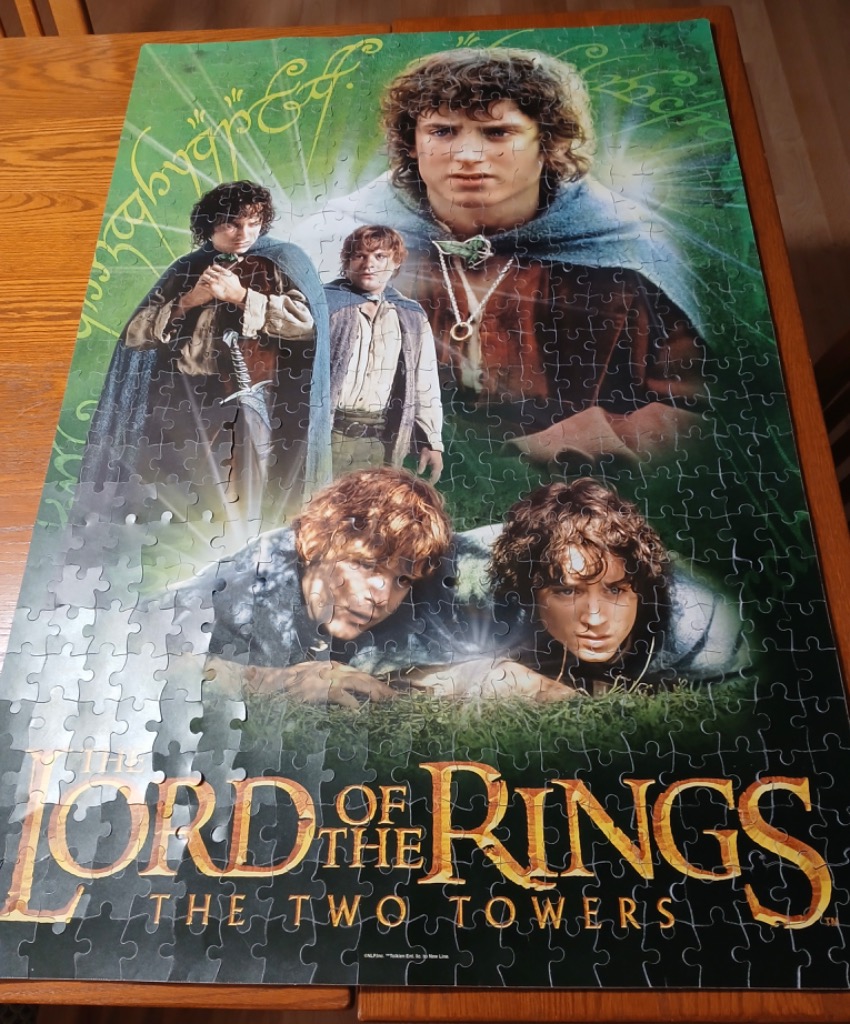 Promotional artwork featuring Frodo Baggins and Samwise Gamgee from The Lord of the Rings: The Two Towers.