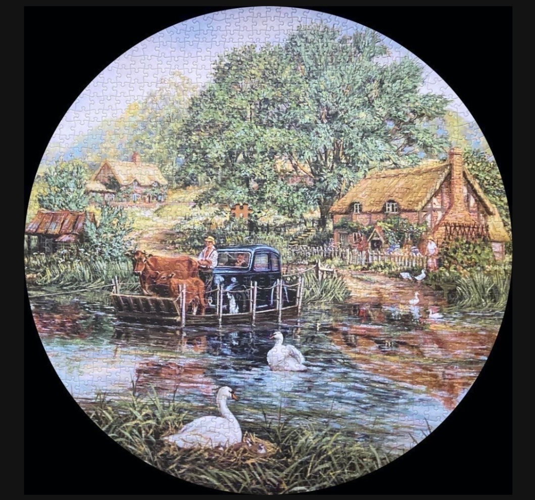 A vintage car and cows crossing a river on a ferry in a rustic English countryside village.